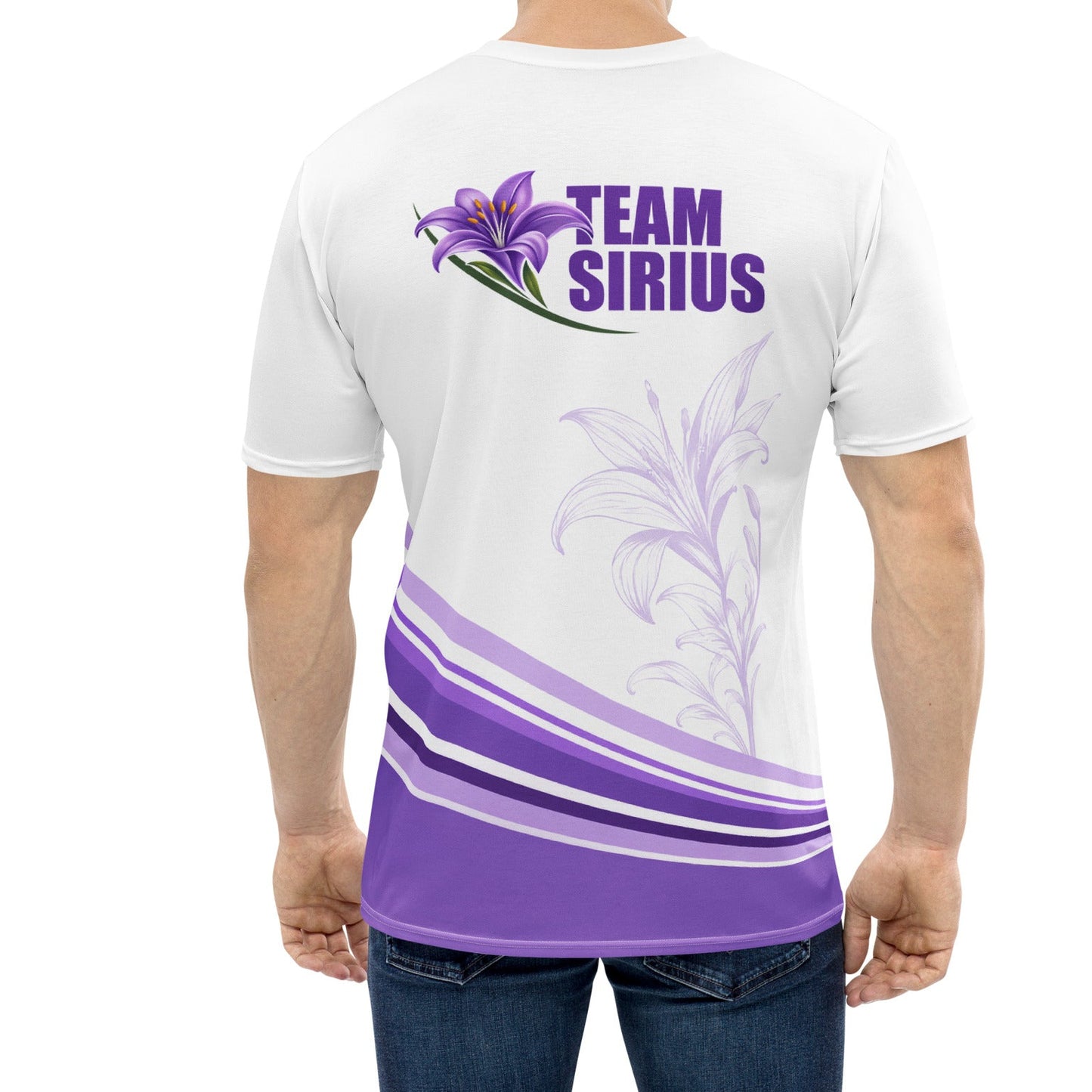 A man viewed from the back wearing a white short-sleeve t-shirt with a purple graphic on the back. The graphic features a purple lily flower, the text 'TEAM SIRIUS' in purple, and purple and white wavy stripes near the hem.